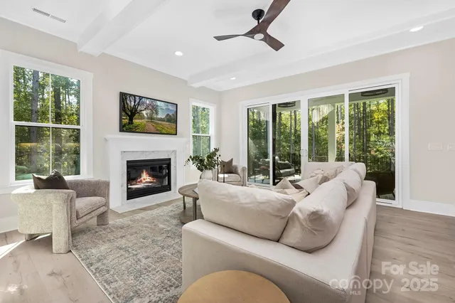 a living room with furniture large window and a fireplace