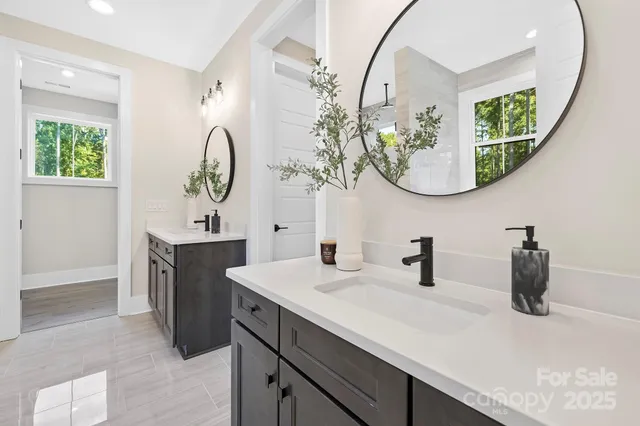 a bathroom with a double vanity sink and a mirror