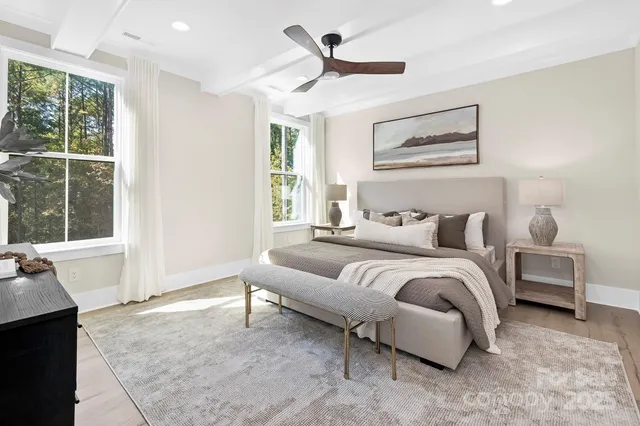 a spacious bedroom with a bed and a large window