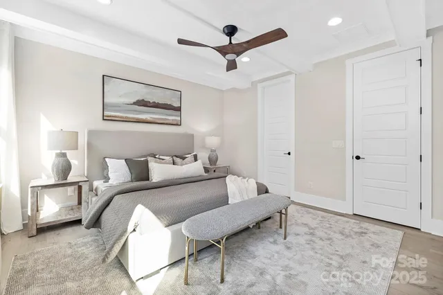 a spacious bedroom with a bed and a lamp