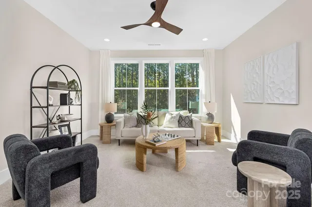 a living room with furniture and a large window
