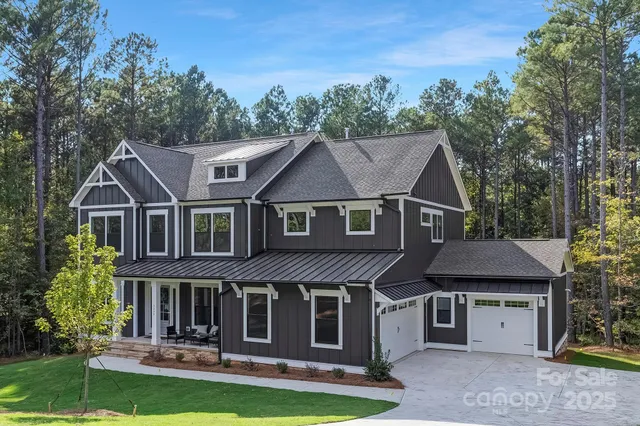 a aerial view of a house next to a yard