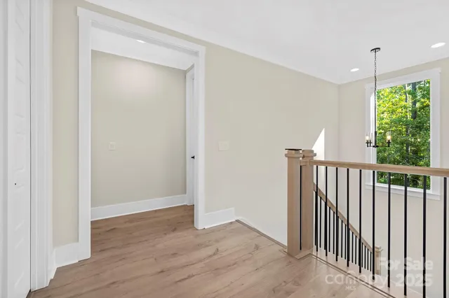 a view of hallway with wooden floor