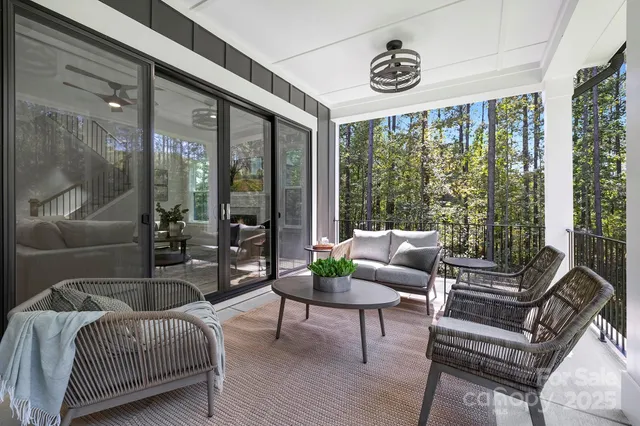 a living room with furniture and a floor to ceiling window