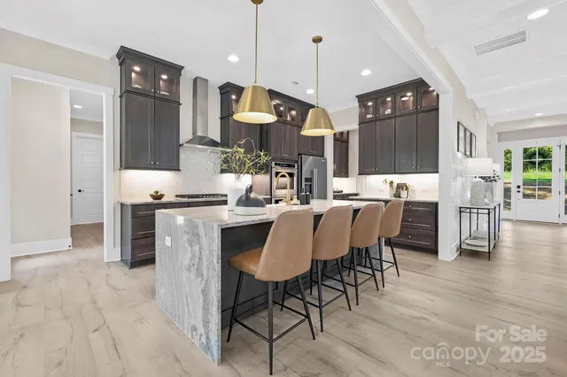 a large kitchen with a table and chairs