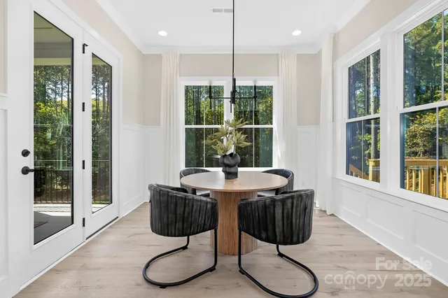 a view of a dining room with furniture wooden floor and a chandelier