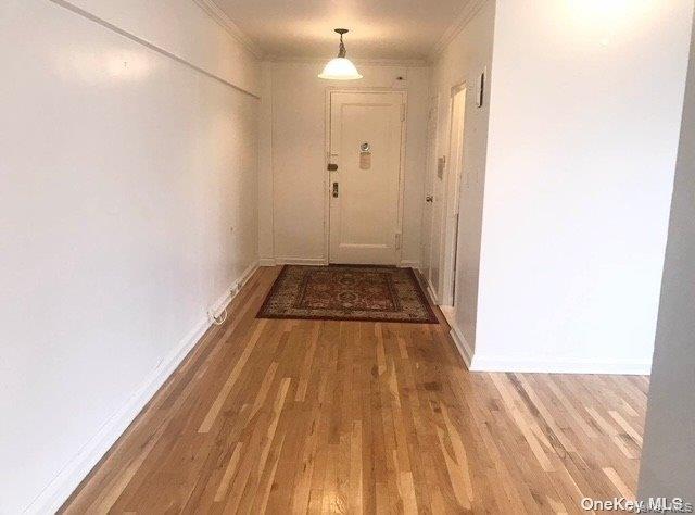 81-15 35th Avenue, Unit 6 Queens, NY 11372 - Photo 2 of 7 a view of a room with wooden floor and white walls