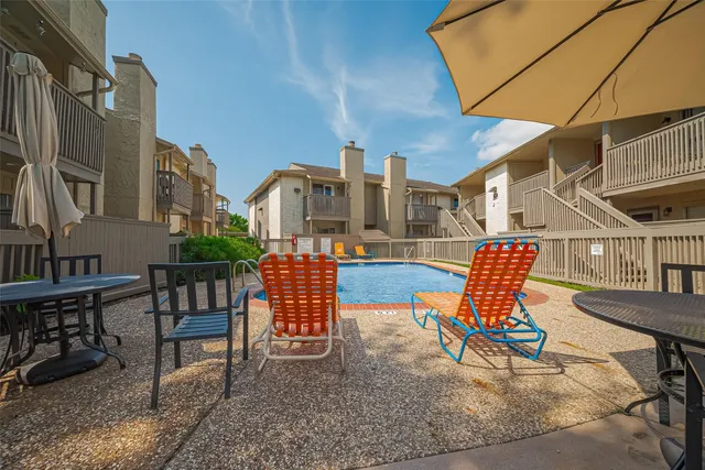 a backyard of a house with table and chairs