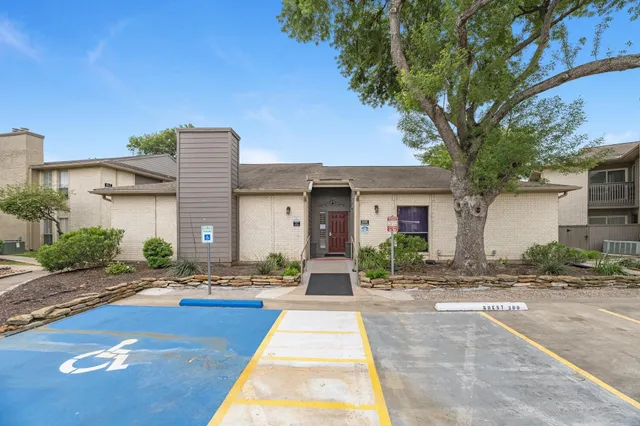 a front view of a house with yard and green space