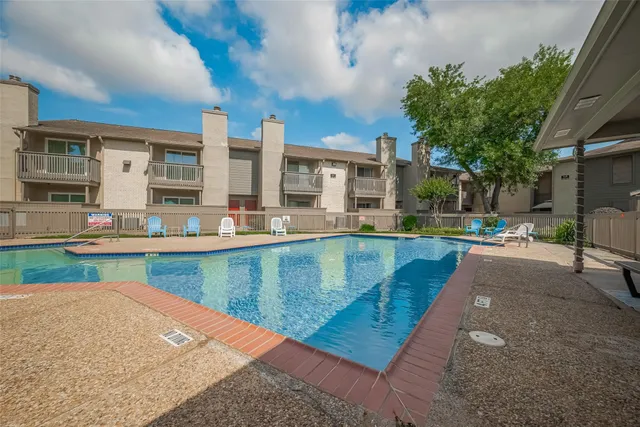 a view of a swimming pool with a patio