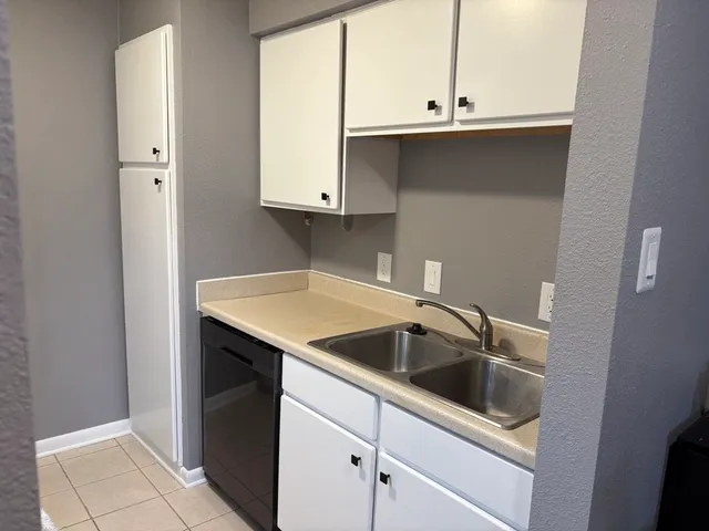 a kitchen with a sink and cabinets