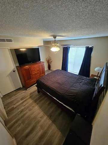 a bed room with a bed and a television