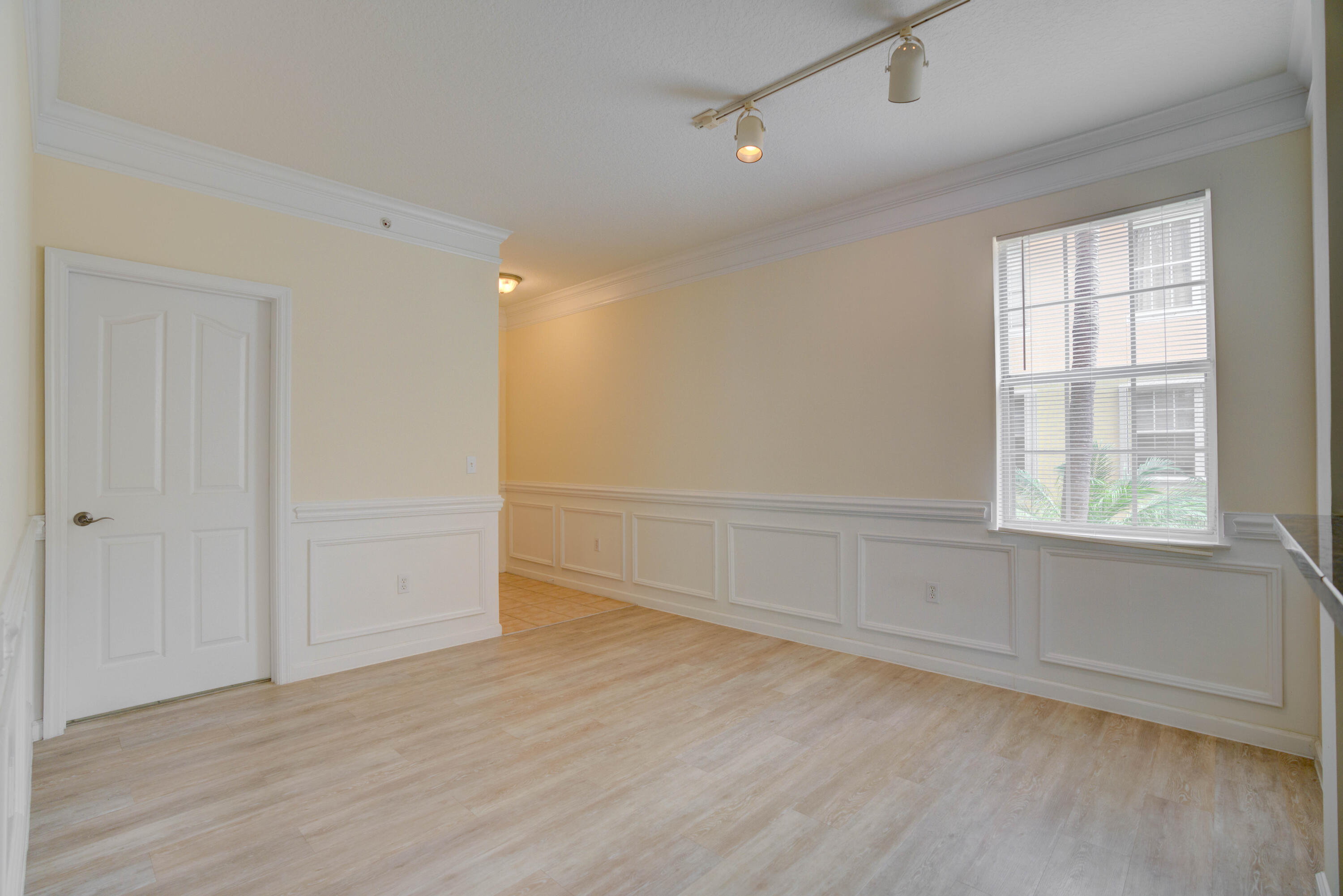 224 Murcia Drive, Unit 201 Jupiter, FL 33458 - Photo 12 of 36 an empty room with wooden floor and windows
