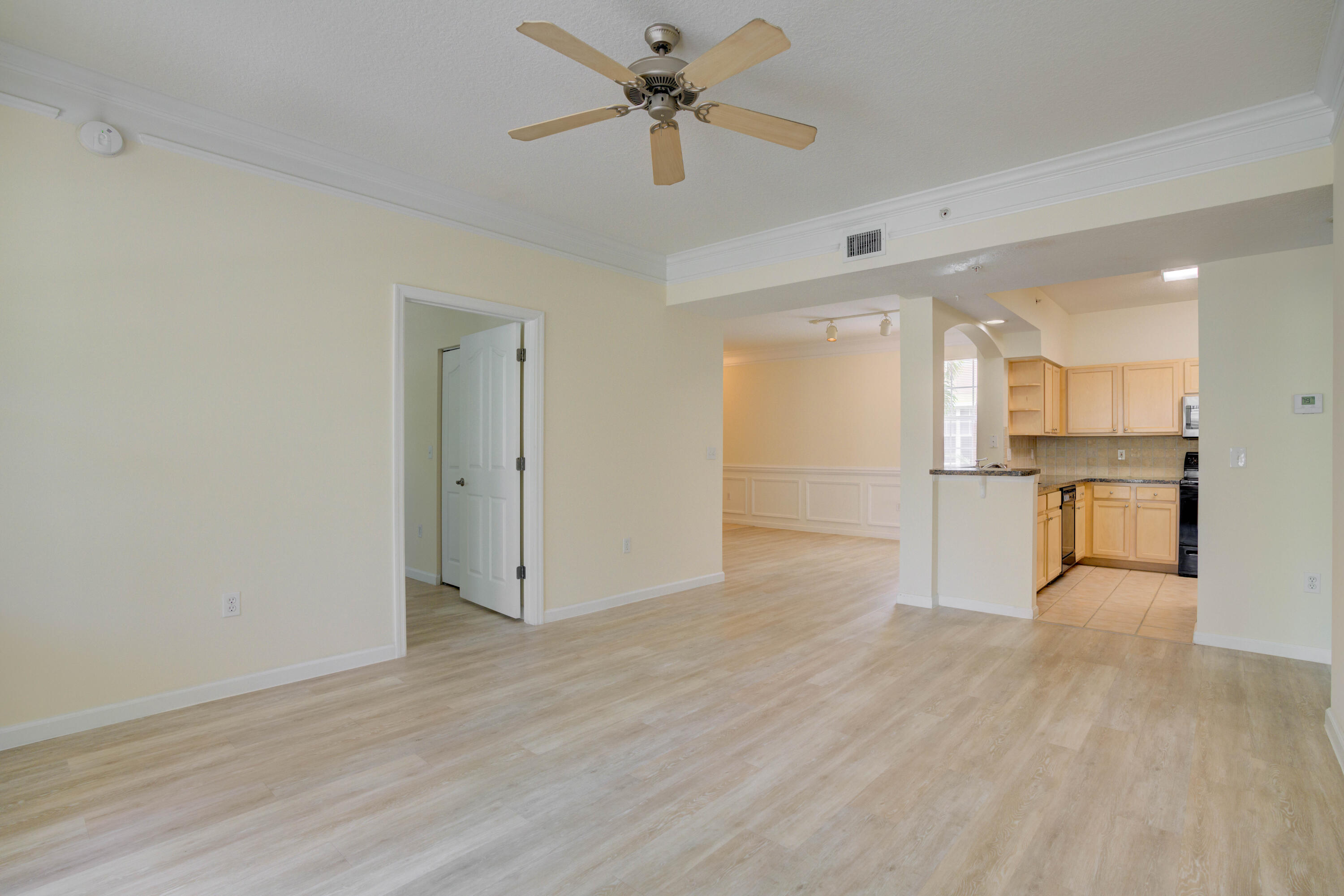 224 Murcia Drive, Unit 201 Jupiter, FL 33458 - Photo 13 of 36 a view of a kitchen with a sink and wooden cabinet