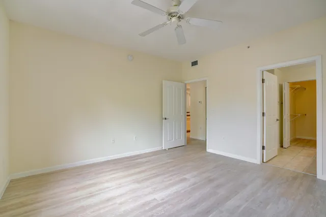 a view of an empty room and wooden floor