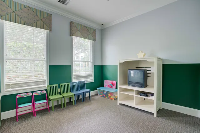 a view of a livingroom with furniture and a ceiling fan