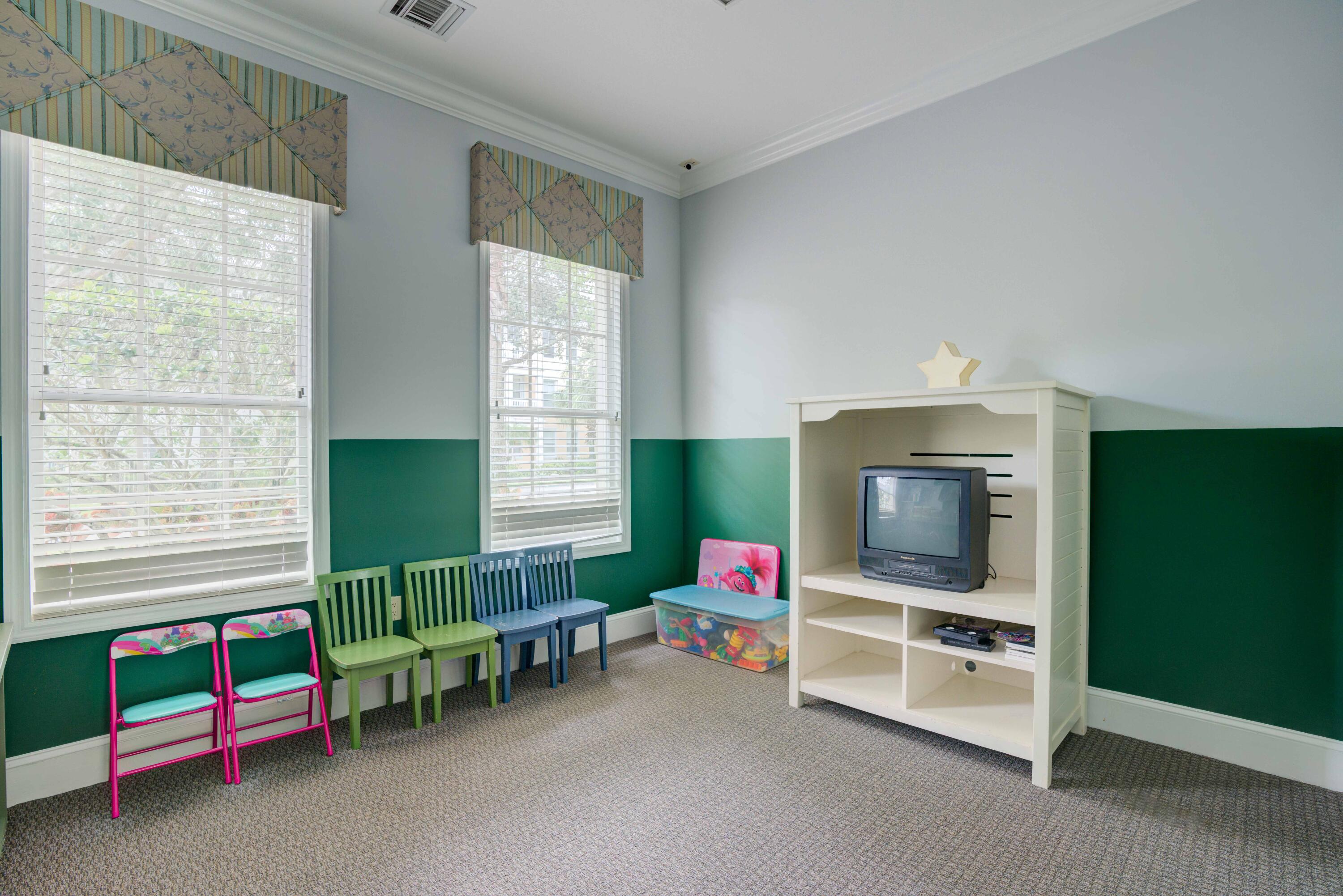 224 Murcia Drive, Unit 201 Jupiter, FL 33458 - Photo 26 of 36 a living room with furniture and a flat screen tv