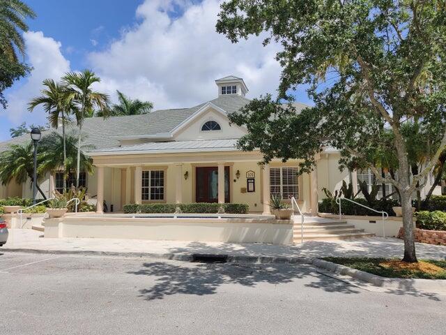 224 Murcia Drive, Unit 201 Jupiter, FL 33458 - Photo 30 of 36 a front view of a house with a garden and trees