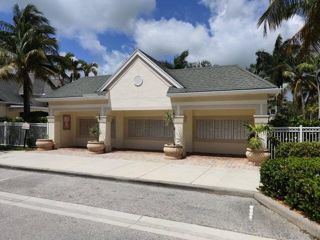 224 Murcia Drive, Unit 201 Jupiter, FL 33458 - Photo 33 of 36 front view of a house with a yard and a garage