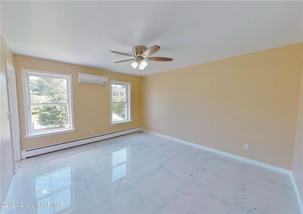 1110 Misty Ridge East Stroudsburg, PA 18302 - Photo 34 of 43 Marble-look tile flooring and a ceiling fan provide both comfort and style in this airy living space.