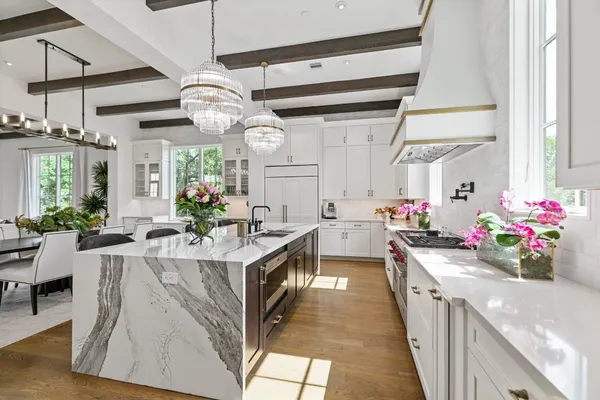 a kitchen with stainless steel appliances a sink stove and cabinets