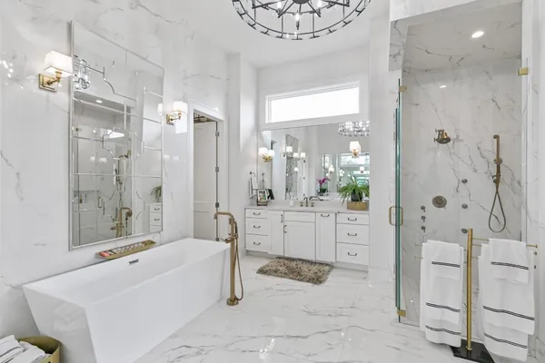 a bathroom with a double vanity sink toilet and shower
