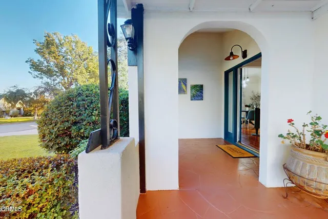 a view of a porch with furniture and a backyard