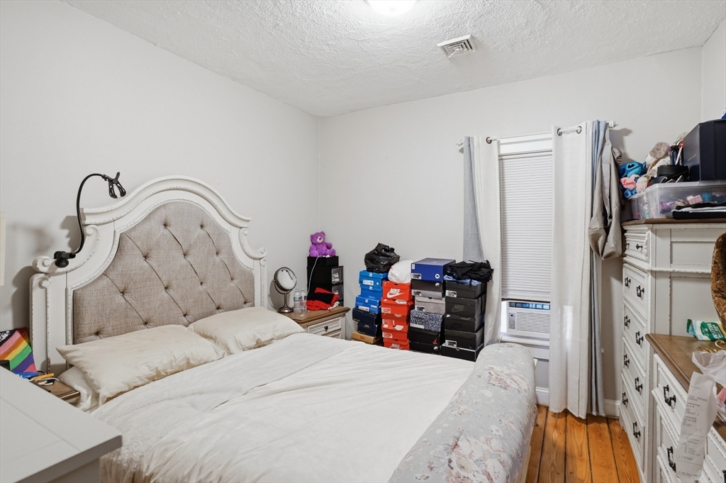 196 Irving Street Fall River, MA 02723 - Photo 28 of 34 a bed room with a bed and a flat tv screen