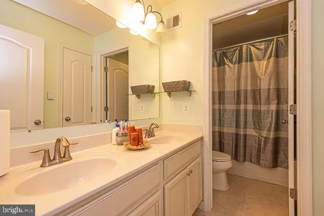 a dining room with furniture and a floor to ceiling window