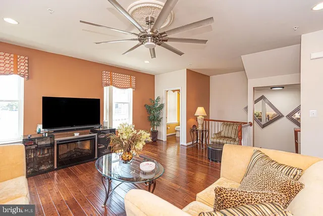 a view of a living room and a window with wooden floor