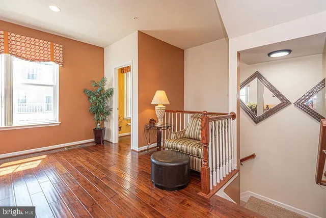 a living room with furniture and a view of kitchen