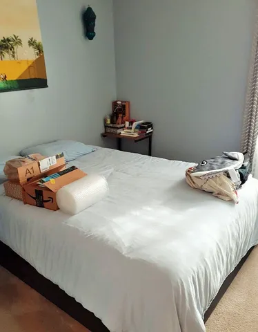 a bedroom with a bed and cabinets