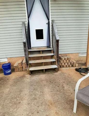 a backyard of a house with wooden floor and seating space