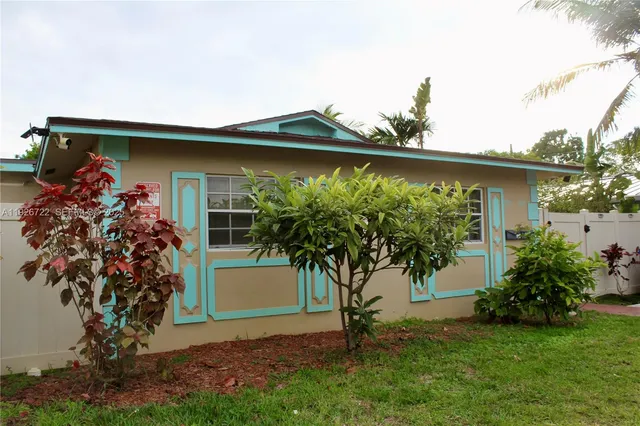 a view of a house with a tree and a yard