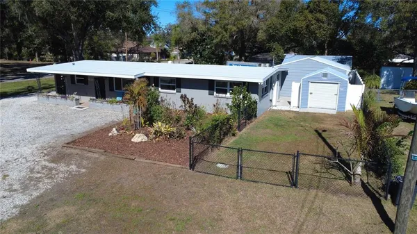 a view of a house with backyard and sitting area