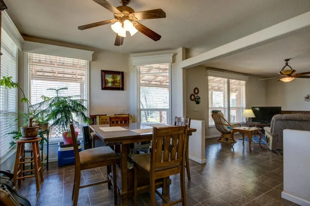 a view of a dining room with furniture and chandelier