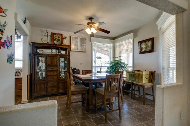 a living room with furniture a piano and a table