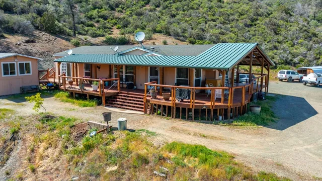 a view of a backyard with plants and a patio