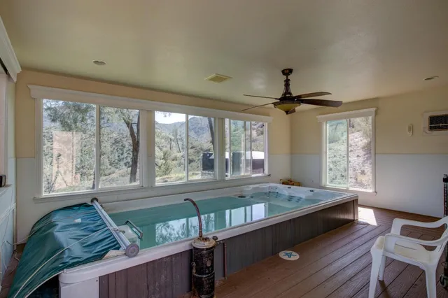 a view of a house with a big yard and large trees