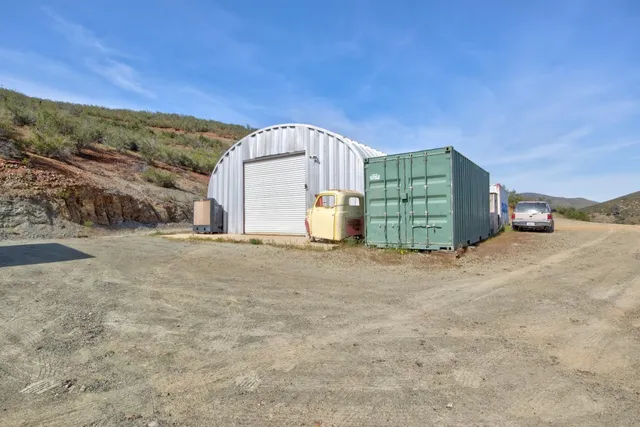 a view of a house with a mountain and a forest
