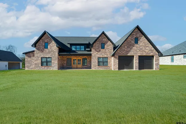 a front view of house with yard and green space