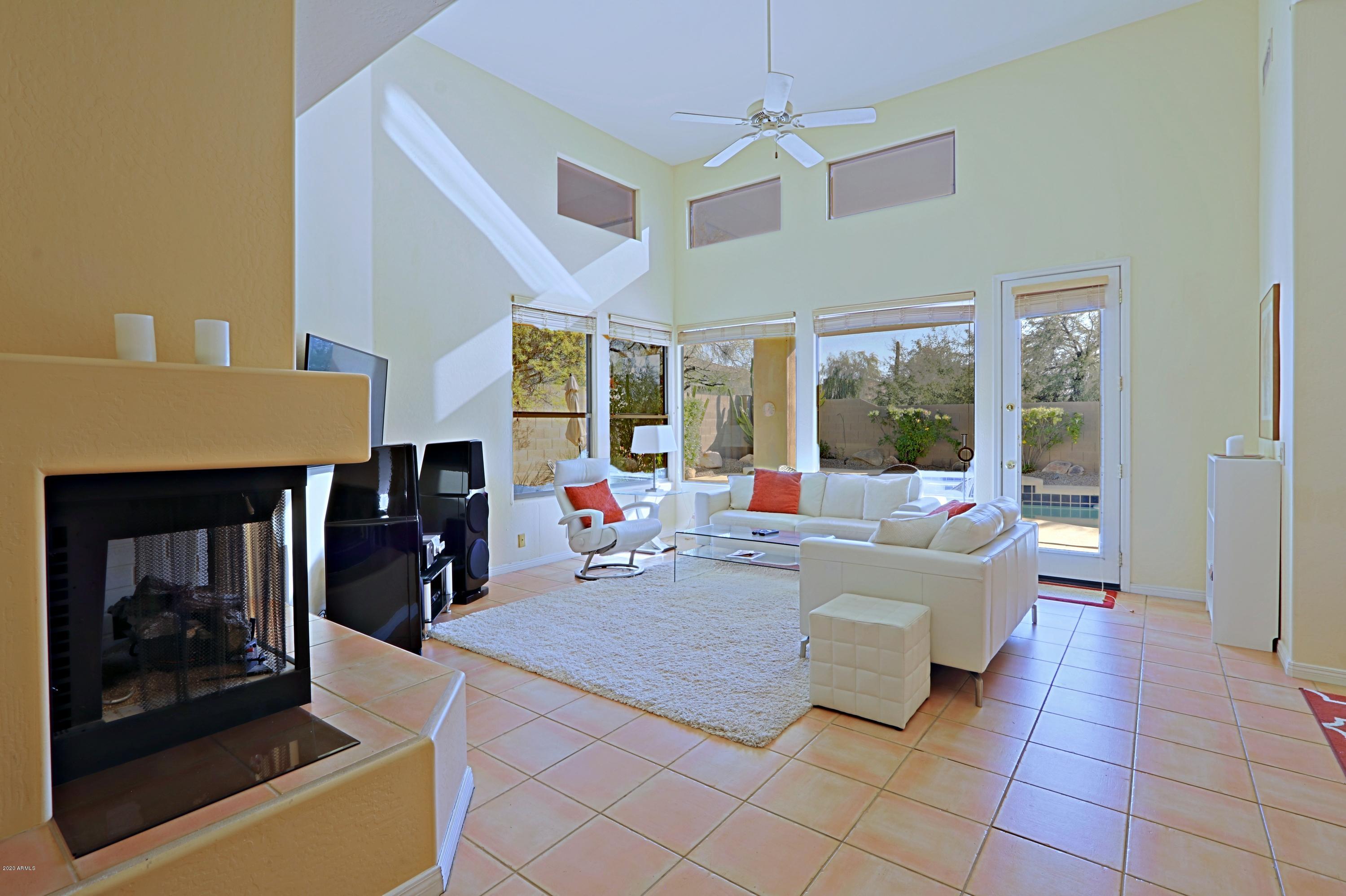 6803 East Eagle Feather Road Scottsdale, AZ 85266 - Photo 4 of 67 a living room with furniture and a fireplace