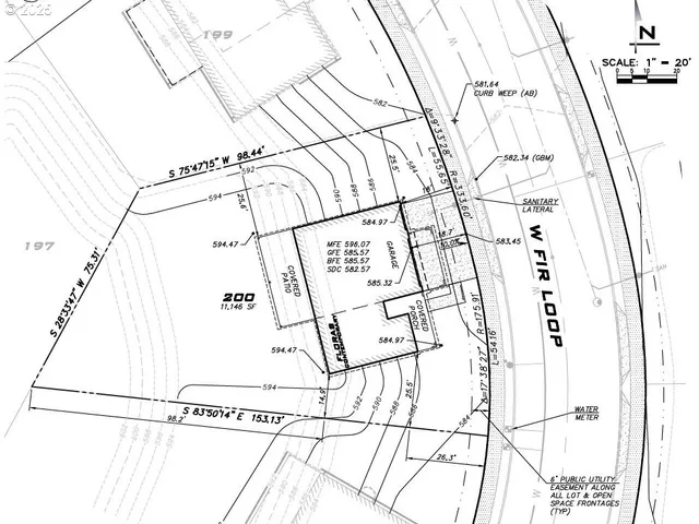 a kitchen with a refrigerator a stove and white cabinets with wooden floor