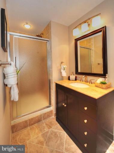 1727 R Street Northwest, Unit 104 Washington, DC 20009 - Photo 8 of 14 a bathroom with a sink vanity and mirror