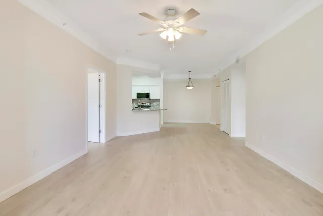 a view of a kitchen with a sink and a refrigerator