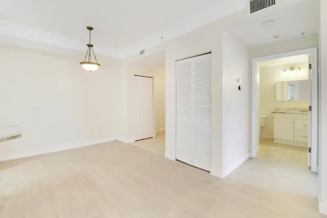 an empty room with a bathroom and a sink