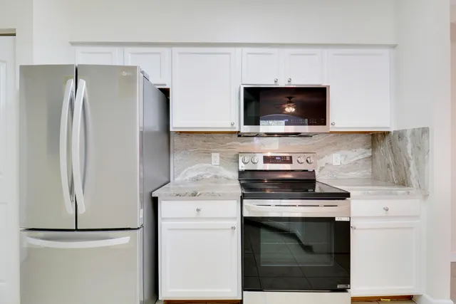 a kitchen with a stove and a refrigerator