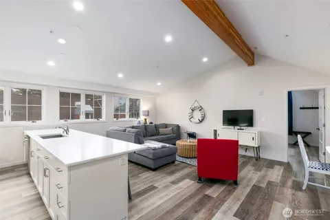 a kitchen with stainless steel appliances a sink a stove a refrigerator and cabinets