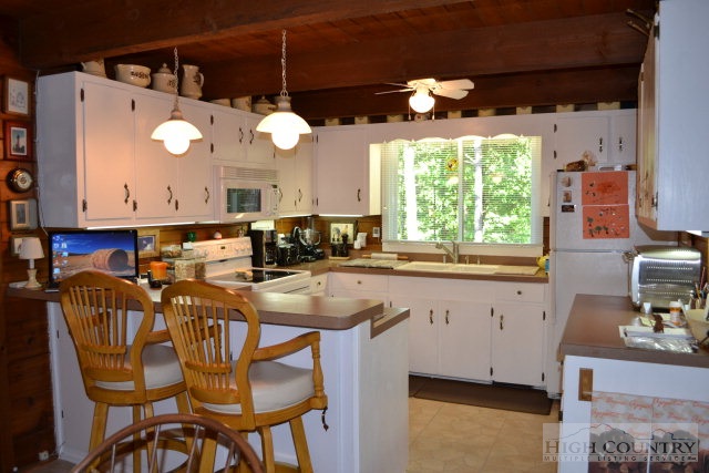 174 Deer Run Road Deep Gap, NC 28618 - Photo 3 of 35 a kitchen with a table and chairs in it