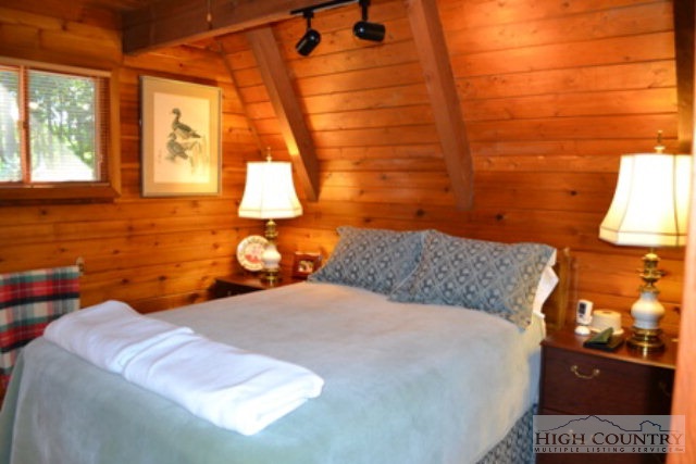 174 Deer Run Road Deep Gap, NC 28618 - Photo 4 of 35 a bedroom with a bed and a window